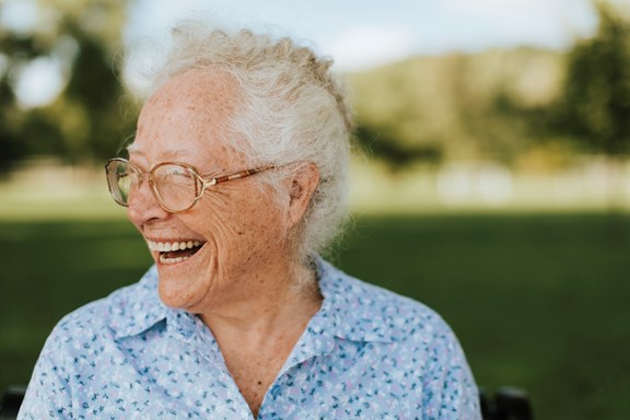 Cheerful Senior Woman Sitting Park